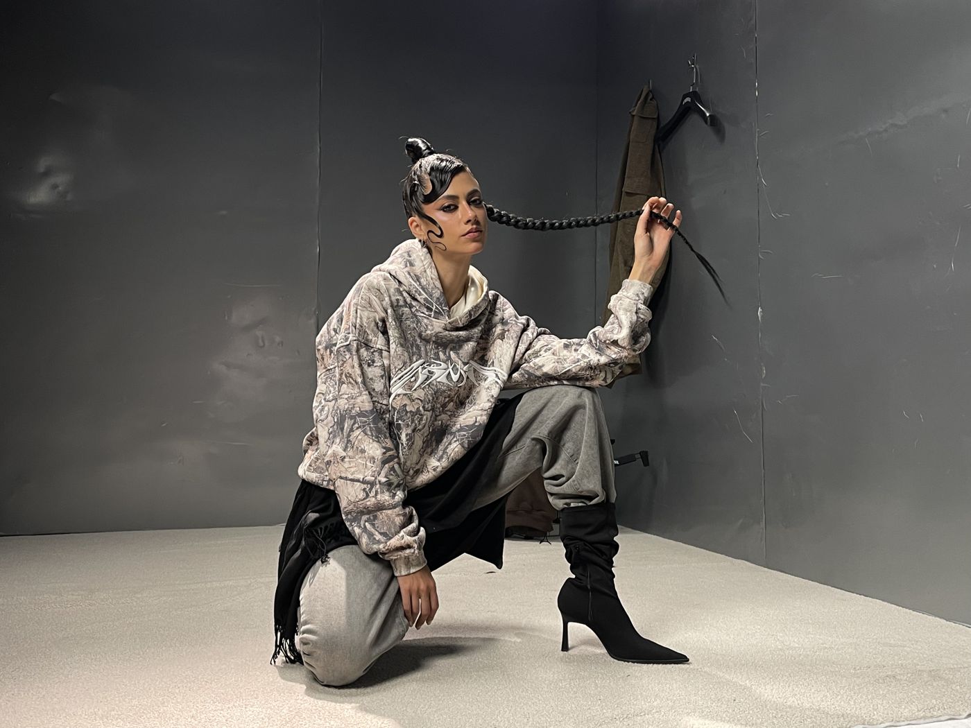 Model posing on The Room set, shot on a phone