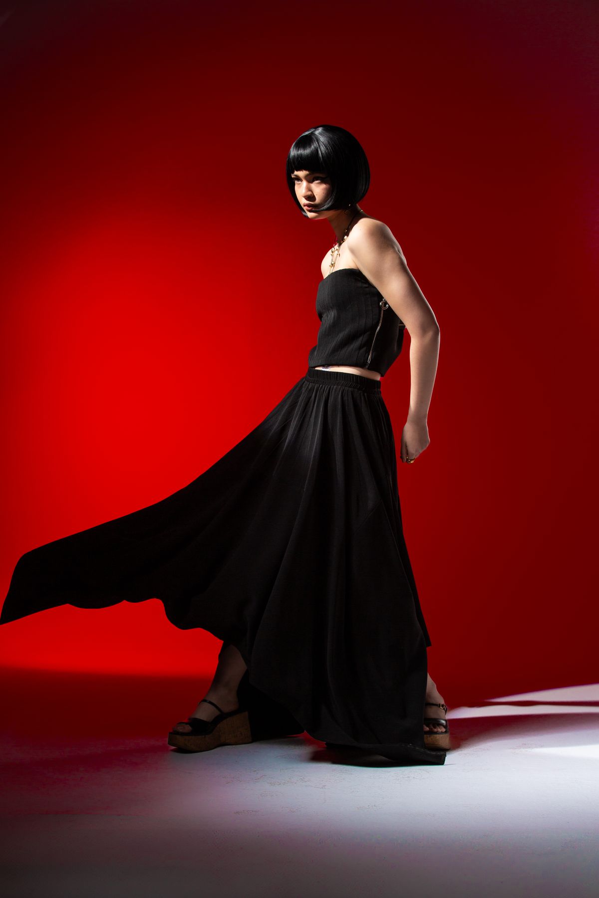 Cut A Dash editorial, figure in black on red